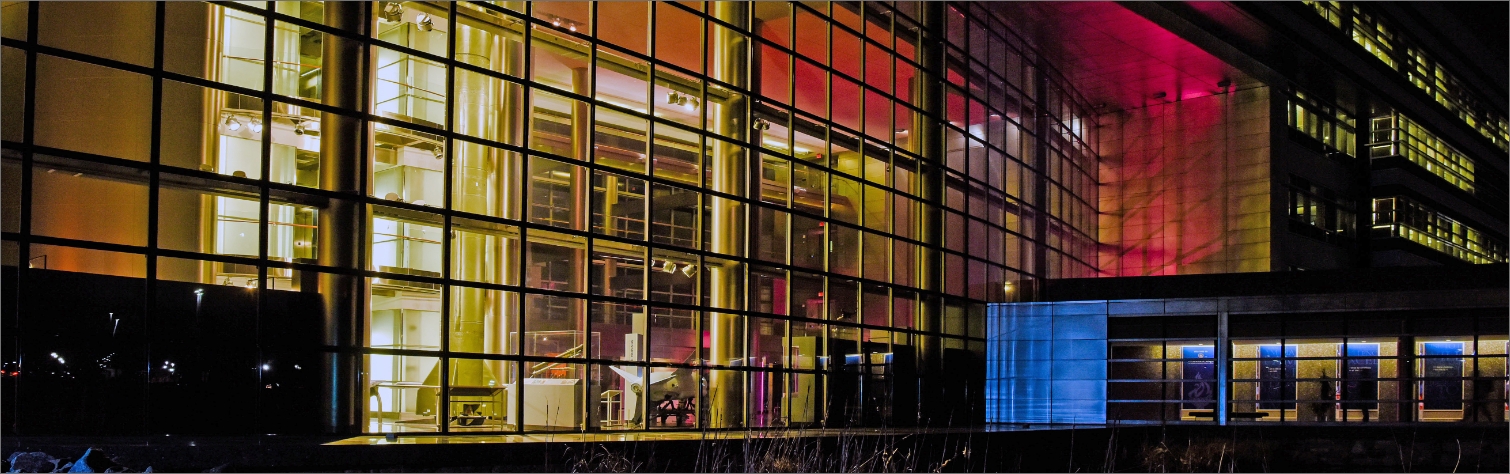 Image of a building with lots of glass at night.
