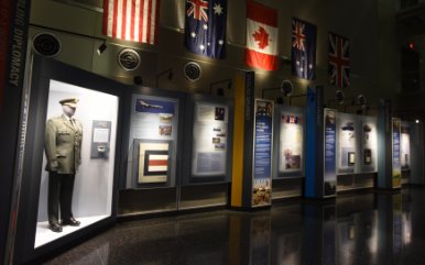 Image of a museum/memorial layout with flags hanging above.