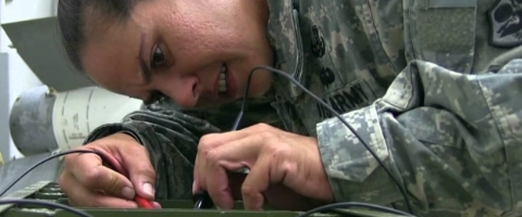 Image of military member testing electronics.
