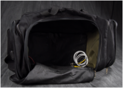 The main compartment of the black duffel bag is open, revealing a coiled white and yellow cable inside.