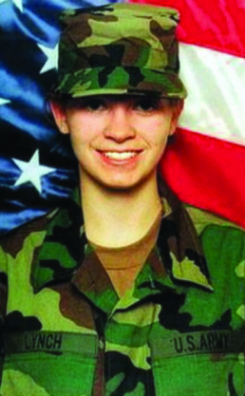 A portrait of a smiling Private First Class Jessica Lynch in her U.S. Army combat uniform, posing in front of an American flag.