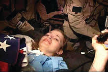 A combat camera image shows an injured Jessica Lynch on a stretcher, surrounded by special operations forces during her rescue from an Iraqi hospital on April 1, 2003.