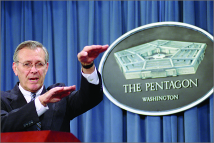 Image of Secretary of Defense Donald Rumsfeld at a podium giving a brief.