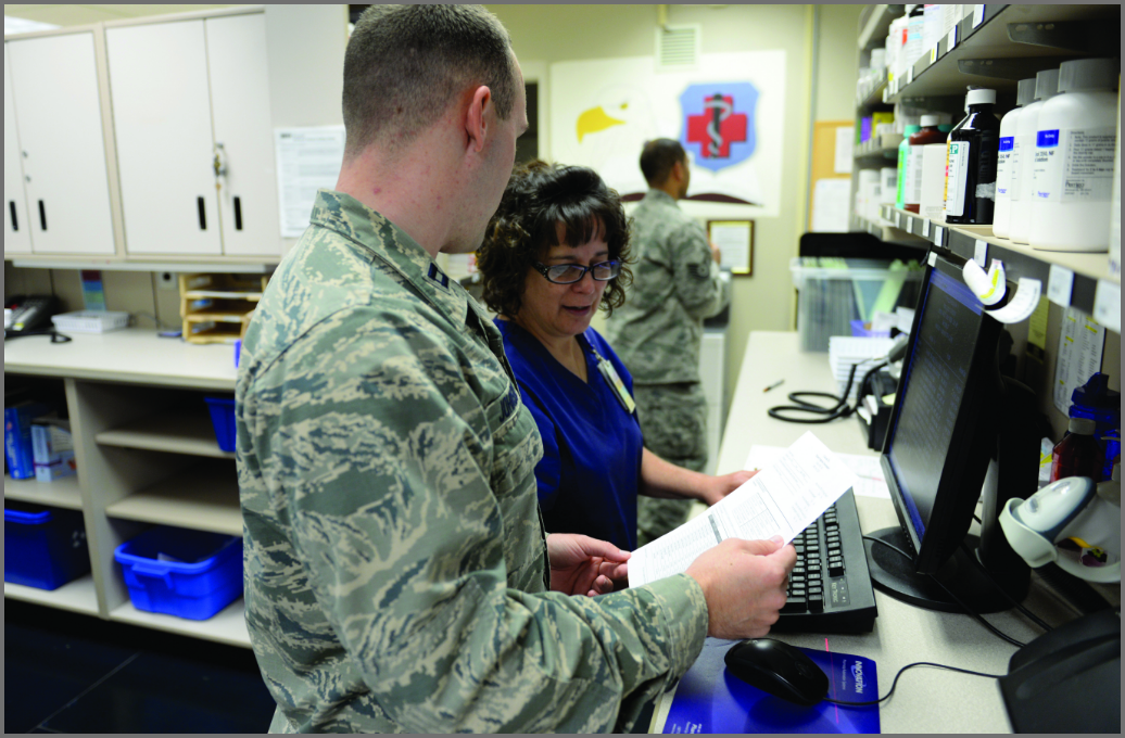 Image of two people talking, the one in the foreground wearing a military uniform