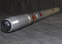 A close-up view of a gray missile's seeker head, which is the guidance system at the tip.