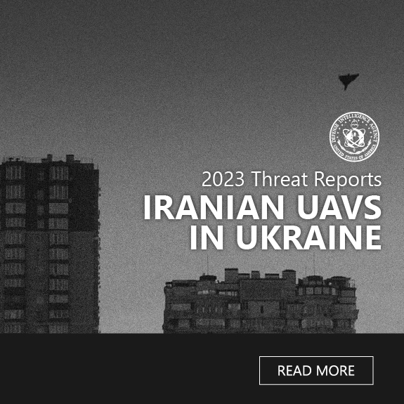 Image of a blue-tinted picture that shows an tall, residential building. Above are the words. Iranian UAVs in Ukraine. To the left is a DIA logo.